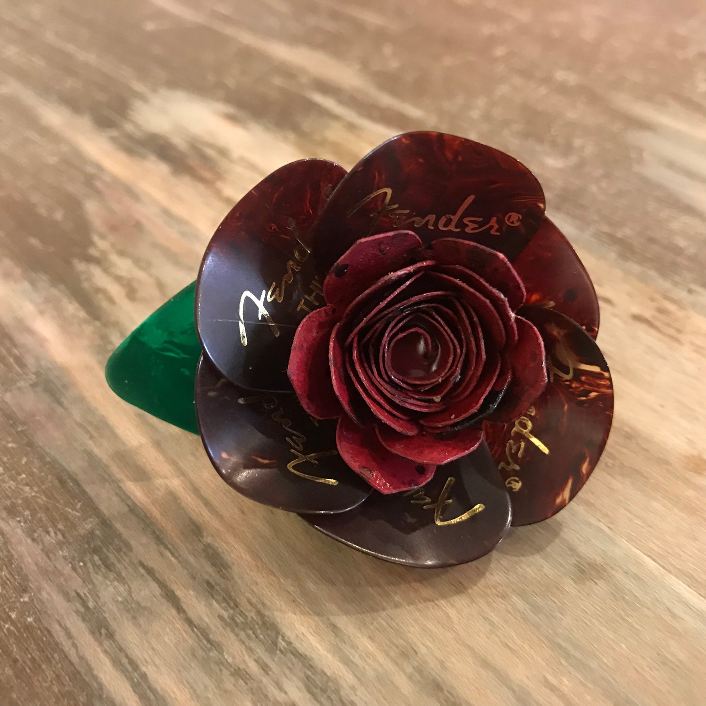 burgundy boutonniere made from guitar picks