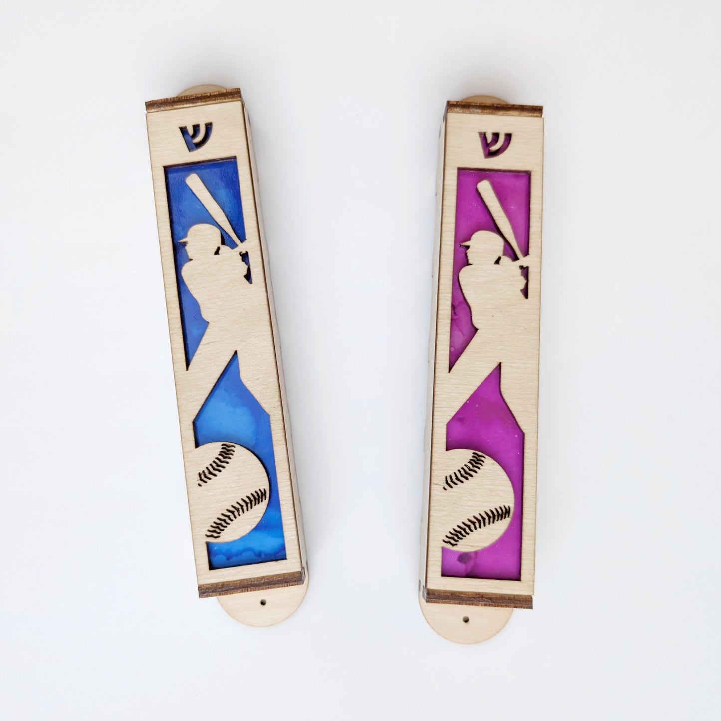 Two wooden bookmarks with silhouettes of a female softball player and ball on a white background